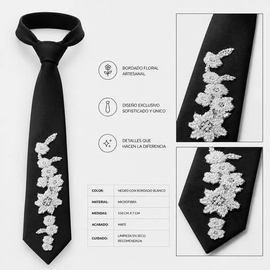 Corbata negra artesanal con bordado floral blanco realizado a mano. Diseño exclusivo de Paola Santos.