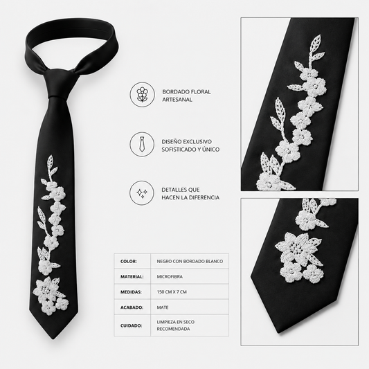 Corbata negra artesanal con bordado floral blanco realizado a mano. Diseño exclusivo de Paola Santos.
